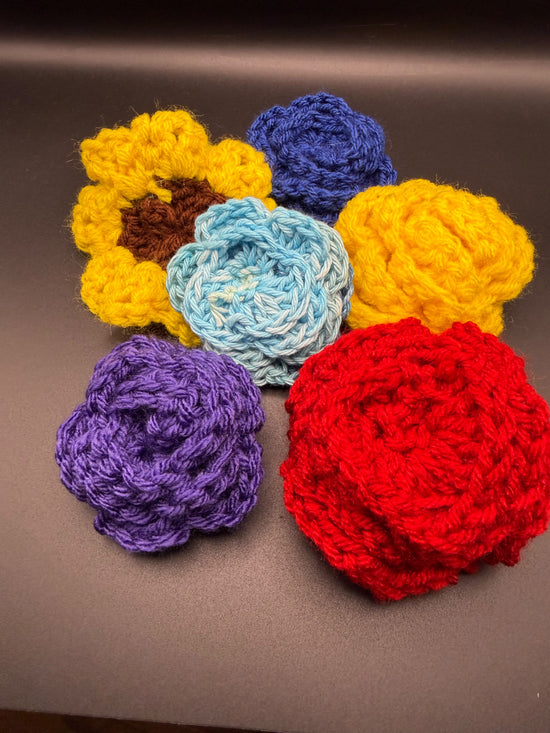 Hand crocheted daisy and rose pins. Can be used as decoration for hats or clothing. Hat not included. Used as demonstration only. 14 available